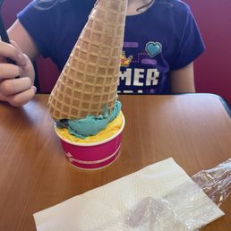 Waffle cone with a scoop of eggnog and Cookie Monster
