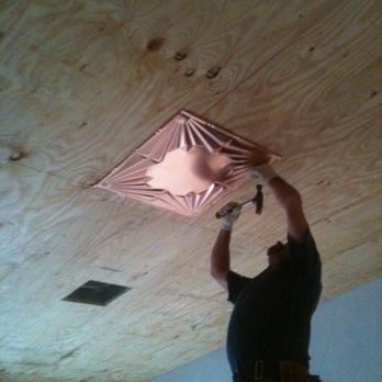 Airtight Vinyl Siding and Windows - James hand nails the first solid copper ceiling tile. - Windows Installation Near Me - Soquel, California