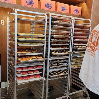 Old Ferry Donut - a man standing in front of a rack of donuts - Donuts Near Me - Buena Park, California Old Ferry Donut - a man standing in front of a rack of donuts - Donuts Near Me - Buena Park, California