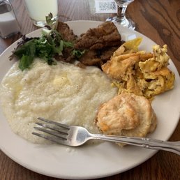 Burnt eggs, a little bit of over cooked fried fish and lumpy Grits