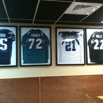 Mama Lucy's Homestyle Cooking - Signed NFL Jerseys of former UM Hurricane greats inside Mama Lucy's Ribs. - Barbeque Near Me - Miami, Florida