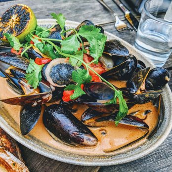 The Dawson - Mussels - gochujang, coconut milk, lemongrass, pickled fresno, charred lime, grilled miche - American Near Me - Chicago, Illinois The Dawson - Mussels - gochujang, coconut milk, lemongrass, pickled fresno, charred lime, grilled miche - American Near Me - Chicago, Illinois
