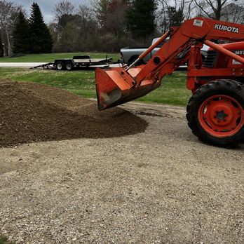 Healey Construction - a tractor and a pile of dirt - General Contractors Near Me