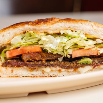 Lucido's Tacos - a sandwich with lettuce and tomato - Mexican Near Me - Chicago, Illinois