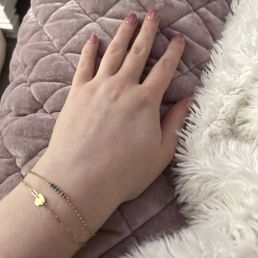 Two permanent bracelets with charms Two permanent bracelets with charms
