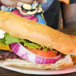Gumbeaux's Cajun Cafe - My son's burger. He said it was very good and had to take half of it home because of the size.