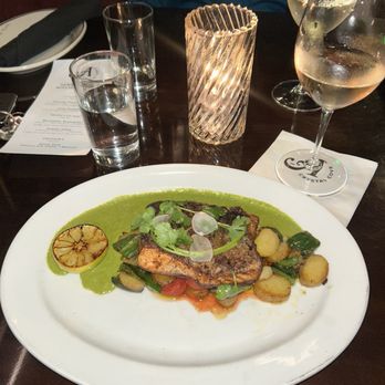 A Crystal Cove - Blackened Scottish Salmon with Mexican Hash, Creamy Cilantro sauce and charred lime. - New American Near Me - Newport Beach, California