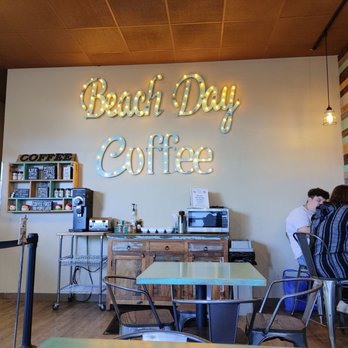 Beach Day Coffee - a person sitting at a table - Coffee & Tea Near Me - Seaside, Oregon Beach Day Coffee - a person sitting at a table - Coffee & Tea Near Me - Seaside, Oregon