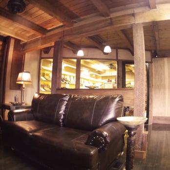 Boss Cigars - a living room with leather furniture - Cigar Bars Near Me - Carrollton, Georgia