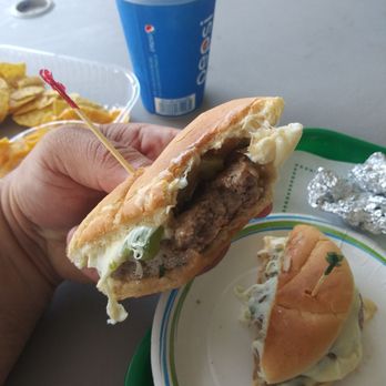 Connors Hot Dog Stand - Me taking a bite of that sandwich which again, was hot! Fresh off the grill. - Burgers Near Me - Angola, New York Connors Hot Dog Stand - Me taking a bite of that sandwich which again, was hot! Fresh off the grill. - Burgers Near Me - Angola, New York