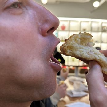 Amelia's -Stutz - Ham and cheese biscuit being devoured - Bakeries Near Me - Indianapolis, Indiana