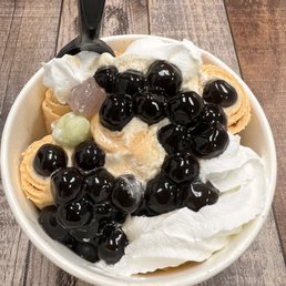 Thai tea rolled ice cream with boba , whipped cream and mocha toppings Thai tea rolled ice cream with boba , whipped cream and mocha toppings