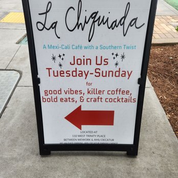 La Chiquiada - Sign pointing from McDonough across from Chick-fil-a to path to La Chiquiada, in the courtyard of AMLI towers, behind Plant House. - Mexican Near Me - Decatur, Georgia