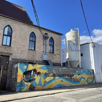 Urban Artifact - a building with a mural on the side of it - Breweries Near Me - Cincinnati, Ohio