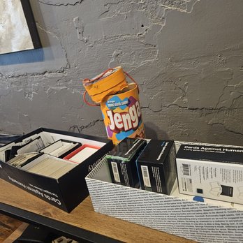 Cravings - a stack of books and a bag of jelvin's on a table - Beer, Wine & Spirits Near Me - Tuscaloosa, Alabama Cravings - a stack of books and a bag of jelvin's on a table - Beer, Wine & Spirits Near Me - Tuscaloosa, Alabama