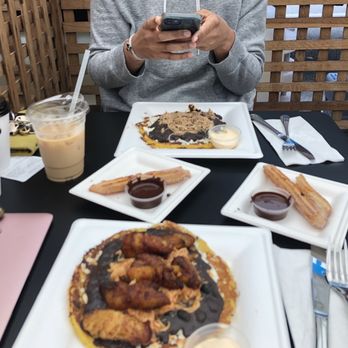 Amara Chocolate & Coffee - Two cachapa. One with chicken. One with chicken and plantains. Also two churros. The cachapa has a savory and sweet pancake taste. - Coffee & Tea Near Me - Pasadena, California Amara Chocolate & Coffee - Two cachapa. One with chicken. One with chicken and plantains. Also two churros. The cachapa has a savory and sweet pancake taste. - Coffee & Tea Near Me - Pasadena, California