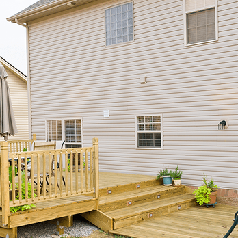 Coto Landscaping - a deck with a chair and umbrella - Landscaping Near Me - Concord, North Carolina Coto Landscaping - a deck with a chair and umbrella - Landscaping Near Me - Concord, North Carolina