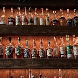 a shelf full of liquor bottles a shelf full of liquor bottles