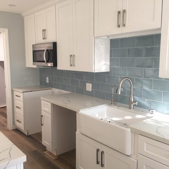 1 Day Kitchen & Bath - a kitchen with white cabinets and a blue backsplash - General Contractors Near Me - Lawndale, California