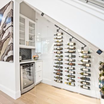 JD Becker Homes - a wine rack under the stairs - General Contractors Near Me