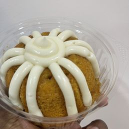 a hand holding a bundt cake a hand holding a bundt cake