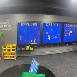 Homewood Science Center - Building blocks wall with an array of blocks positioned underneath so that little ones can   Explore Create Connect