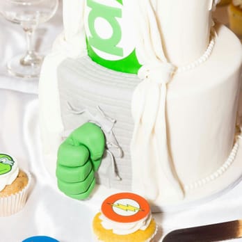 Fantasy Frostings - Superhero themed wedding cake accompanied by cupcakes. Creme Brule, neopolitan, banana pecan and lemon lavender! DELICIOUS! No leftovers! - Custom Cakes Near Me Fantasy Frostings - Superhero themed wedding cake accompanied by cupcakes. Creme Brule, neopolitan, banana pecan and lemon lavender! DELICIOUS! No leftovers! - Custom Cakes Near Me