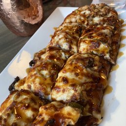 a long piece of pizza on a plate
