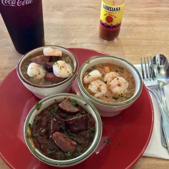 Cafe Le Rue - Clockwise from the top: seafood gumbo, crawfish and shrimp etoufee, and red beans and rice with sausage. - Cajun/Creole Near Me - Columbus, Georgia