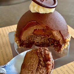 La Chocolatería - Hazelnut Rocher-chocolate medallion, white cream, chocolate shell, mousse, cake, hazelnuts, creamy caramel center