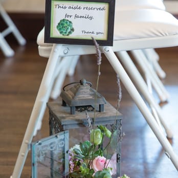 Photosynthesis Floral Design - Lanterns were stuffed with flowers and used along the aisle - Wedding Planning Near Me