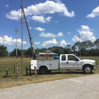 GW Pumps & Purification - Setting a submersible pump used for irrigation with our crane. - Water Purification Services Near Me - Melbourne, Florida