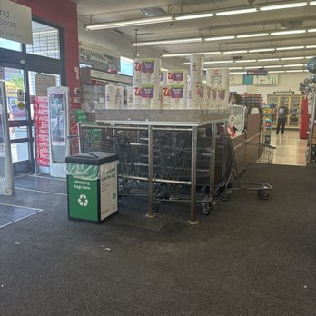 Walgreens - Carts - A stack of shopping carts is positioned near the entrance of a Walgreens in Chicago, IL, with a recycling bin nearby and store interior visible in the background. - Drugstores Near Me - Chicago, Illinois