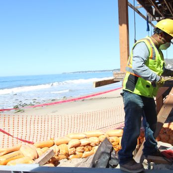 Alpha Structural - a construction worker working on the beach - General Contractors Near Me - Sunland, California