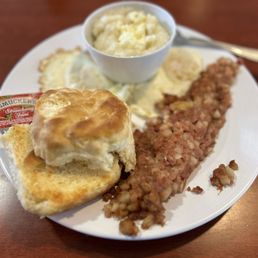 Corn beef hash, over easy eggs, grits and biscuit