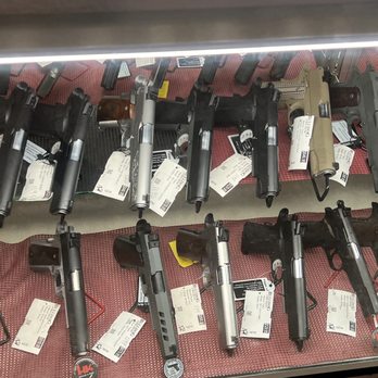 Bulldog Firearms - A glass display case contains multiple handguns and pistols, each with tags, at Bulldog Firearms in Rio Rancho, NM, a licensed firearms dealer. - Guns & Ammo Near Me - Rio Rancho, New Mexico
