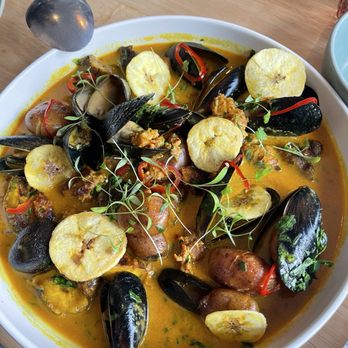 Lenox  - Adobo mussels...the adobo spiced coconut broth was so good, I would not let them take the plate away - Latin American Near Me - Seattle, Washington