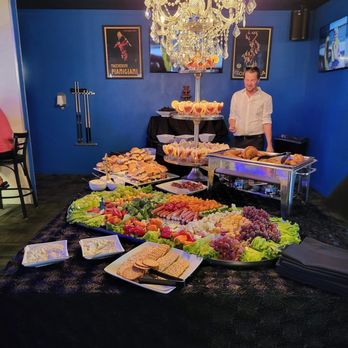 Cruiser's - a man standing in front of a buffet table - Lounges Near Me - Cape Coral, Florida Cruiser's - a man standing in front of a buffet table - Lounges Near Me - Cape Coral, Florida