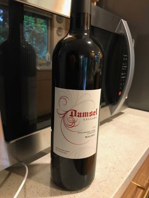 Photo of Damsel Cellars - Woodinville, WA, US. a bottle of wine on a counter