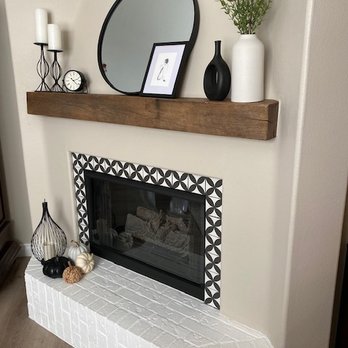 RG Construction - a fireplace with a mirror above it - General Contractors Near Me