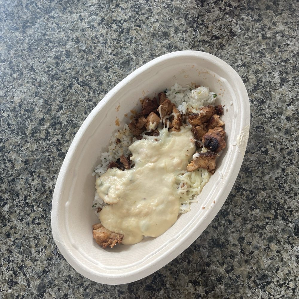 Bowl with white rice, queso, chicken, cheese, and guac. Bowl with white rice, queso, chicken, cheese, and guac.
