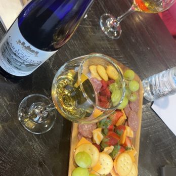 Ole' Orleans Wines and Spirits -  bottle of wine and a platter of food - Wine Tasting Room Near Me - Jefferson, Louisiana