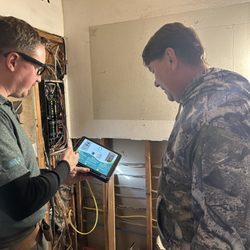 Emerald State Electric - Dennis, providing a consultation summary of the electrical panel inspection with a client in Tacoma.