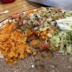Los Hermanos Dos - The sides that came with the Molcajete-rice, beans, pico, guacamole, sour cream + lettuce