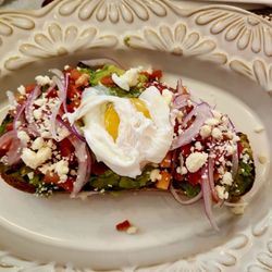 Roses and Berries Cafe - Avocado toast with poached egg, onion, feta, and tomato