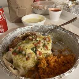 Carnitas burrito which comes with rice and beans. Also queso with chips.