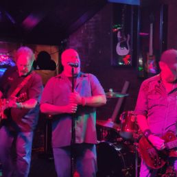 three men playing guitars three men playing guitars