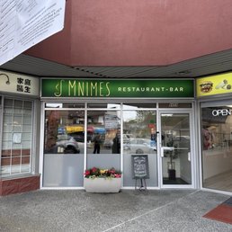 Exterior outside entrance of Mnimes Restaurant & Bar - exterior of mnimes in unassuming strip mall on 6459 victoria drive - Vancouver, British Columbia Exterior outside entrance of Mnimes Restaurant & Bar - exterior of mnimes in unassuming strip mall on 6459 victoria drive - Vancouver, British Columbia