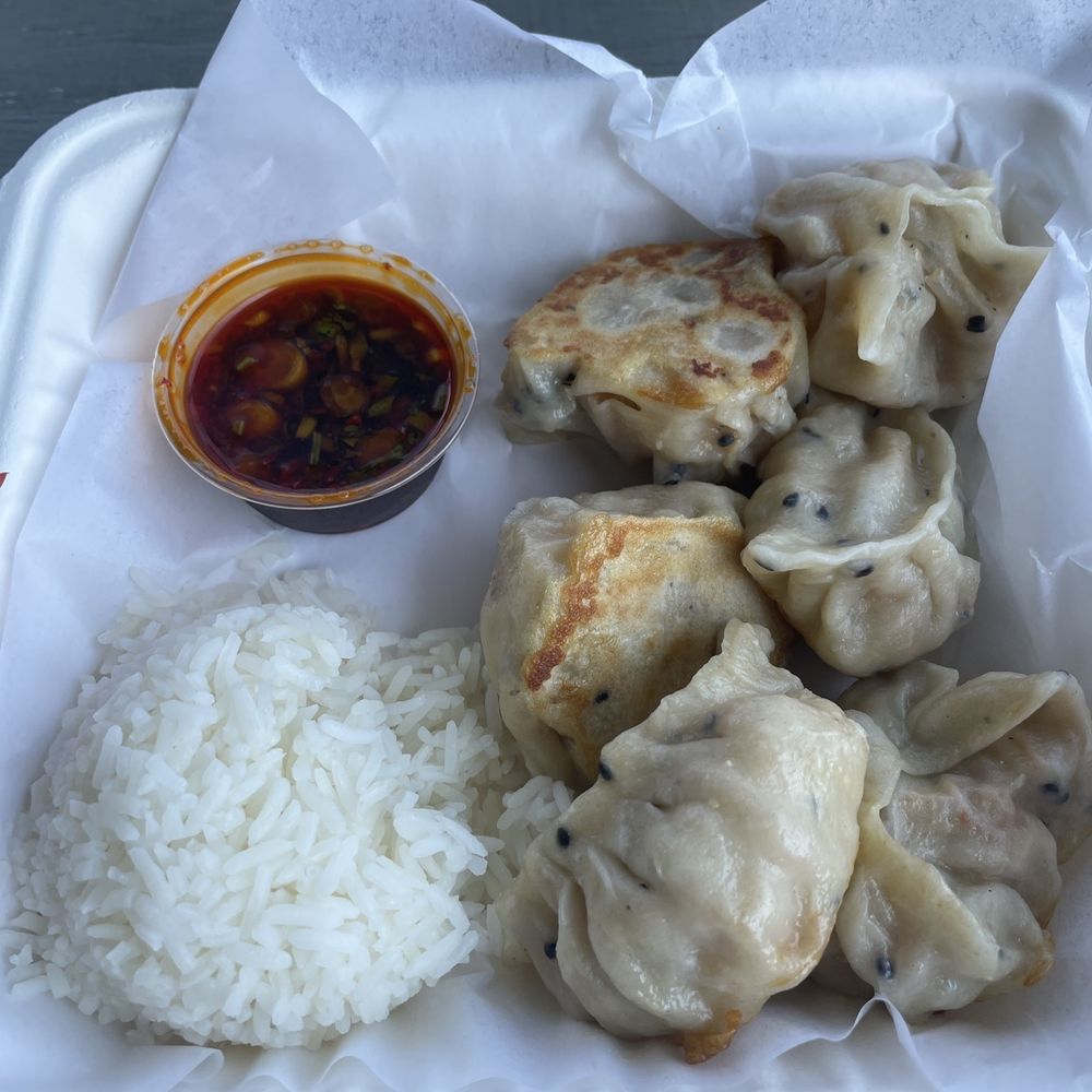 Tofu dumpling meal with rice and spicy sauce .