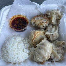Tofu dumpling meal with rice and spicy sauce .